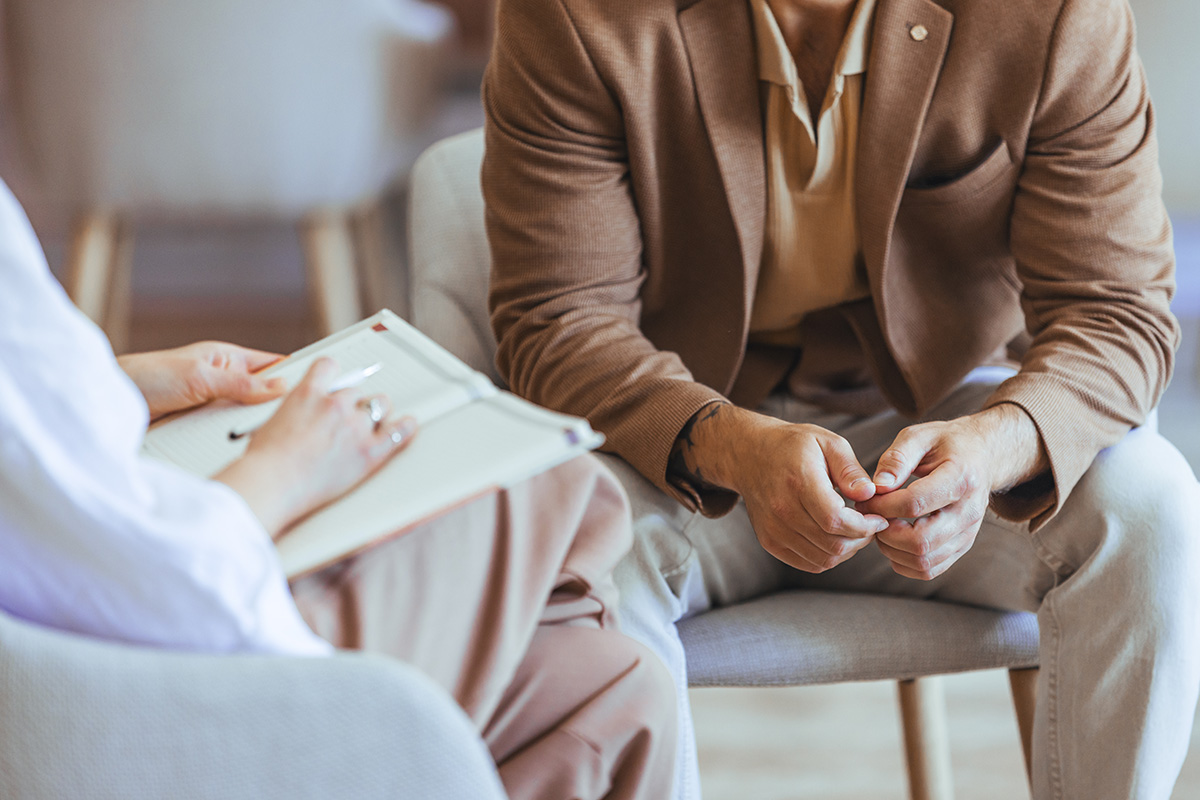 Two people sit during a therapy session.