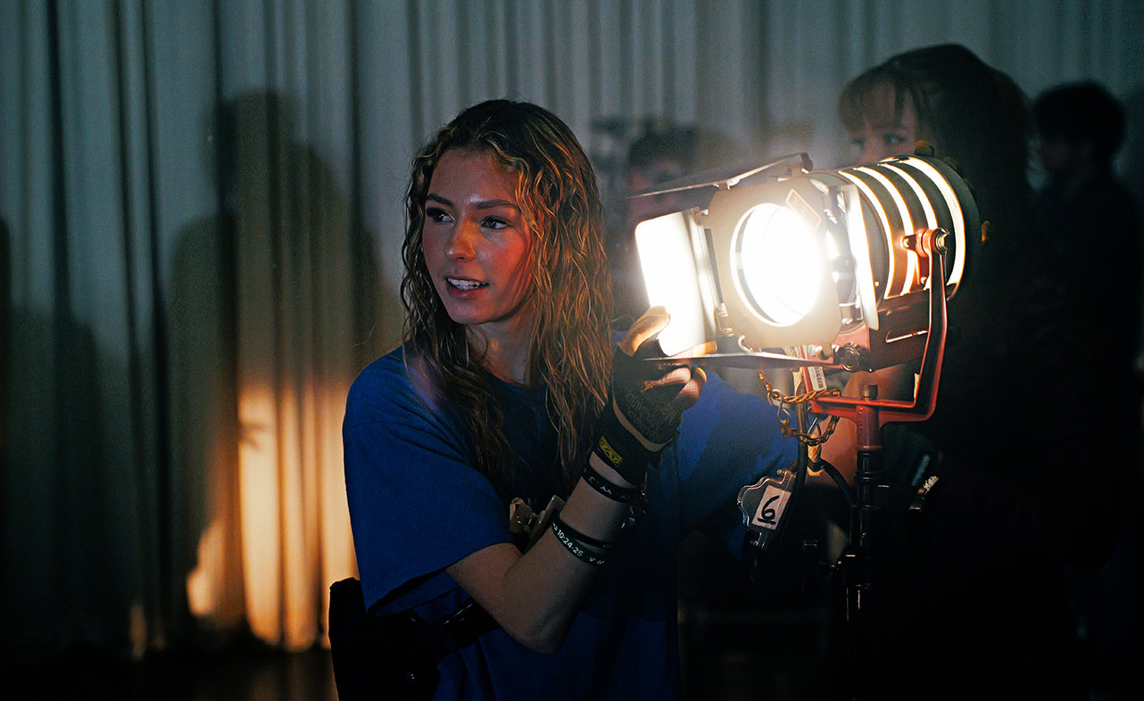 An Okahoma City Community College digital cinema production students works with lighting.