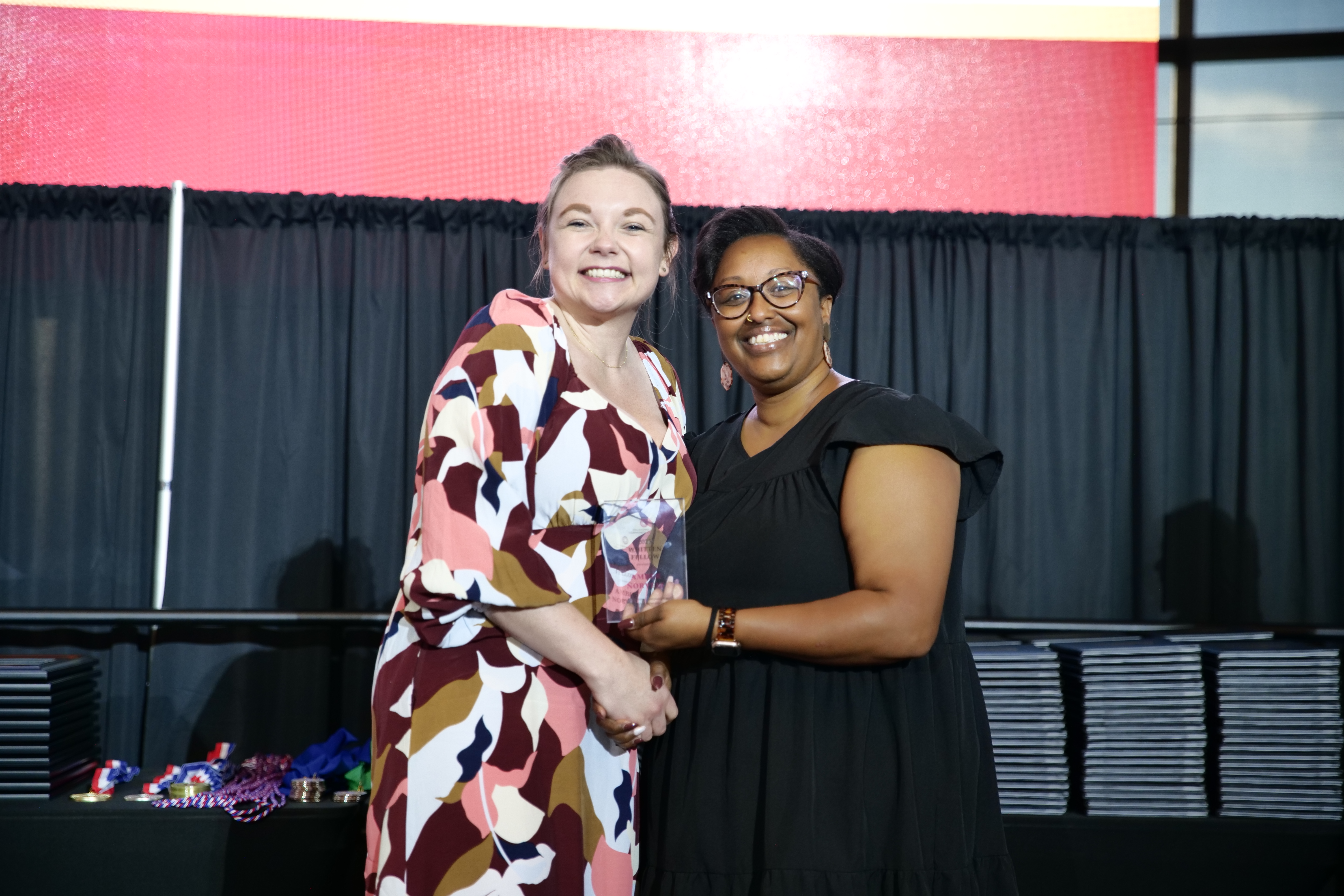 Amber Norvell receives a Whitten Fellow award from Crystal Mohamed, trip coordinator and director of OCCC’s TRIO programs.